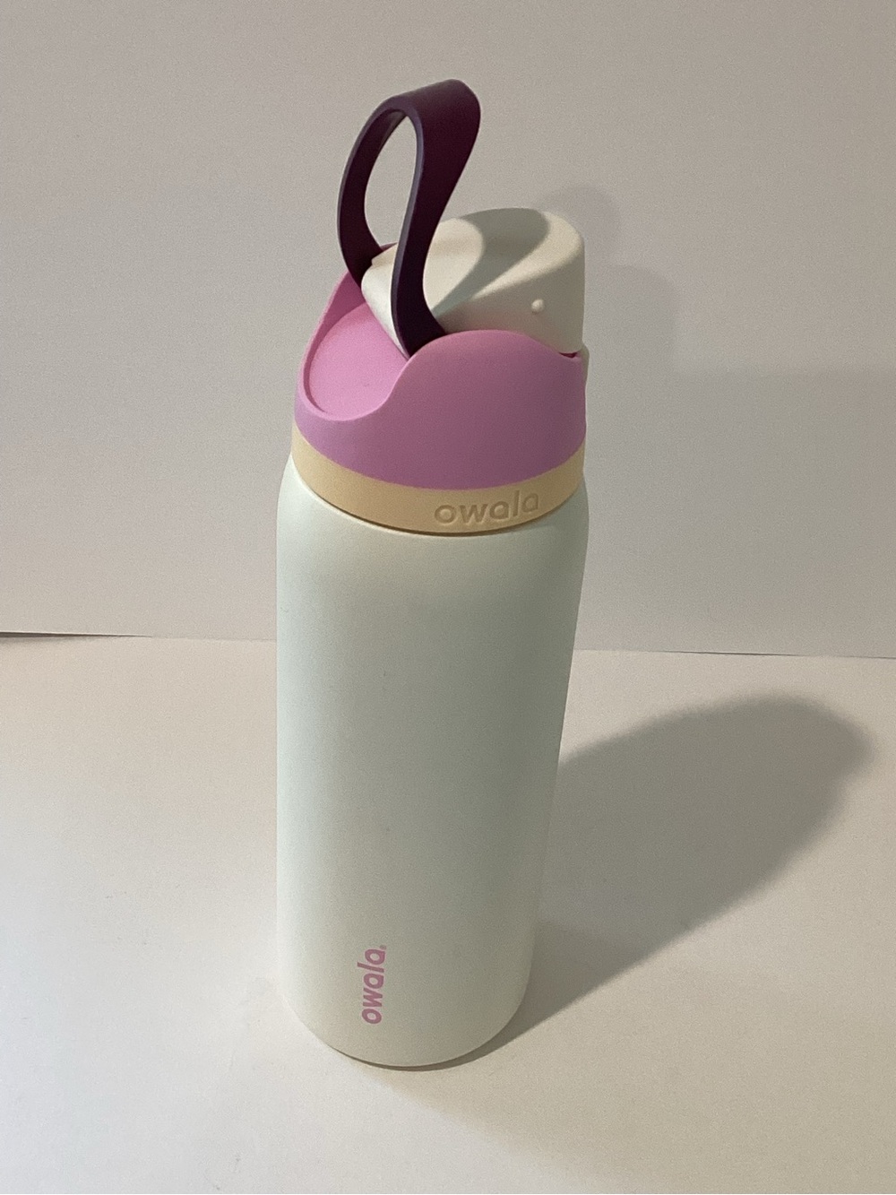 Owala White Water Bottle with Pink Accents and Plum Carry Loop